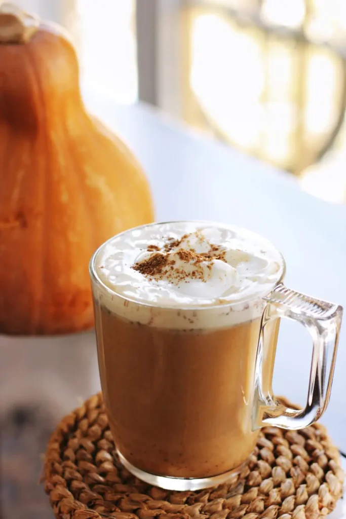 Pumpkin Spice Latte Recipe – Better Than Starbucks Homemade pumpkin spice latte with whipped cream and cinnamon in a glass mug