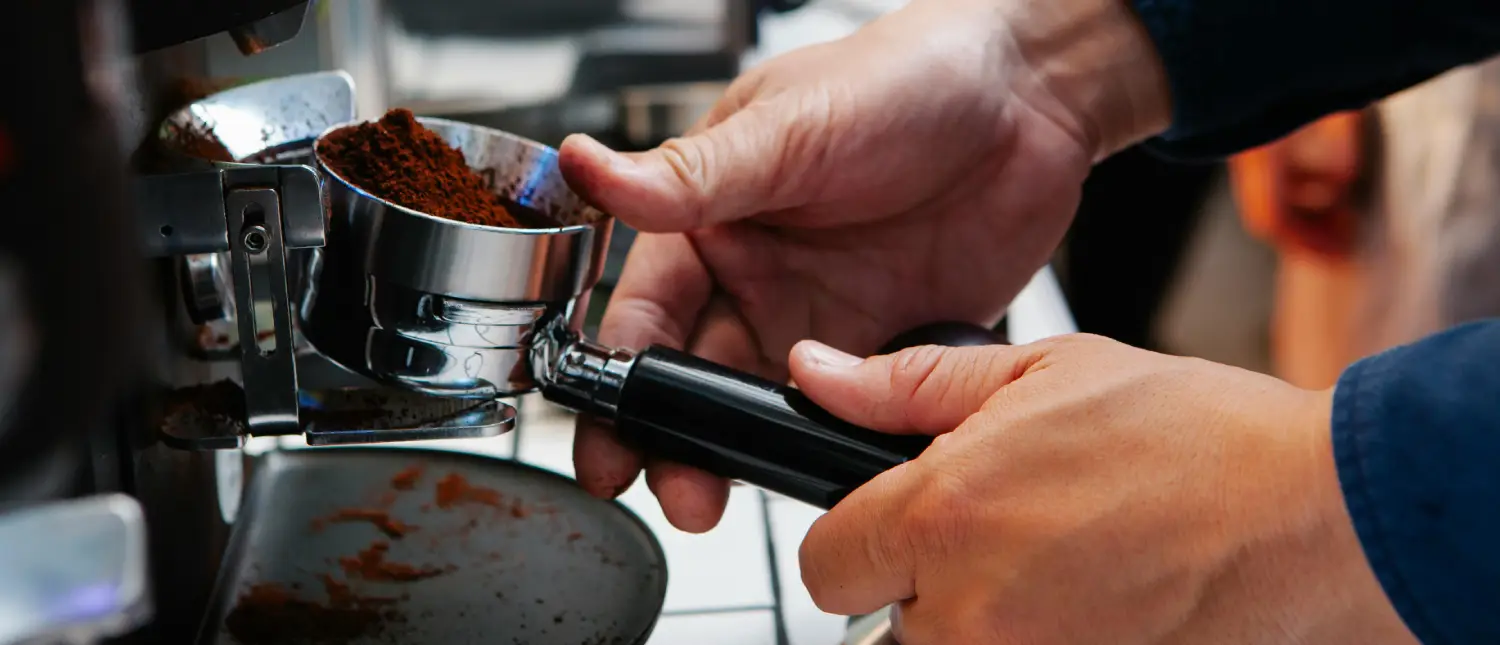 Espresso Puck Prep Techniques: Why They Matter Now☕ 2 Barista preparing to extract an espresso shot after espresso puck prep techniques and tamping