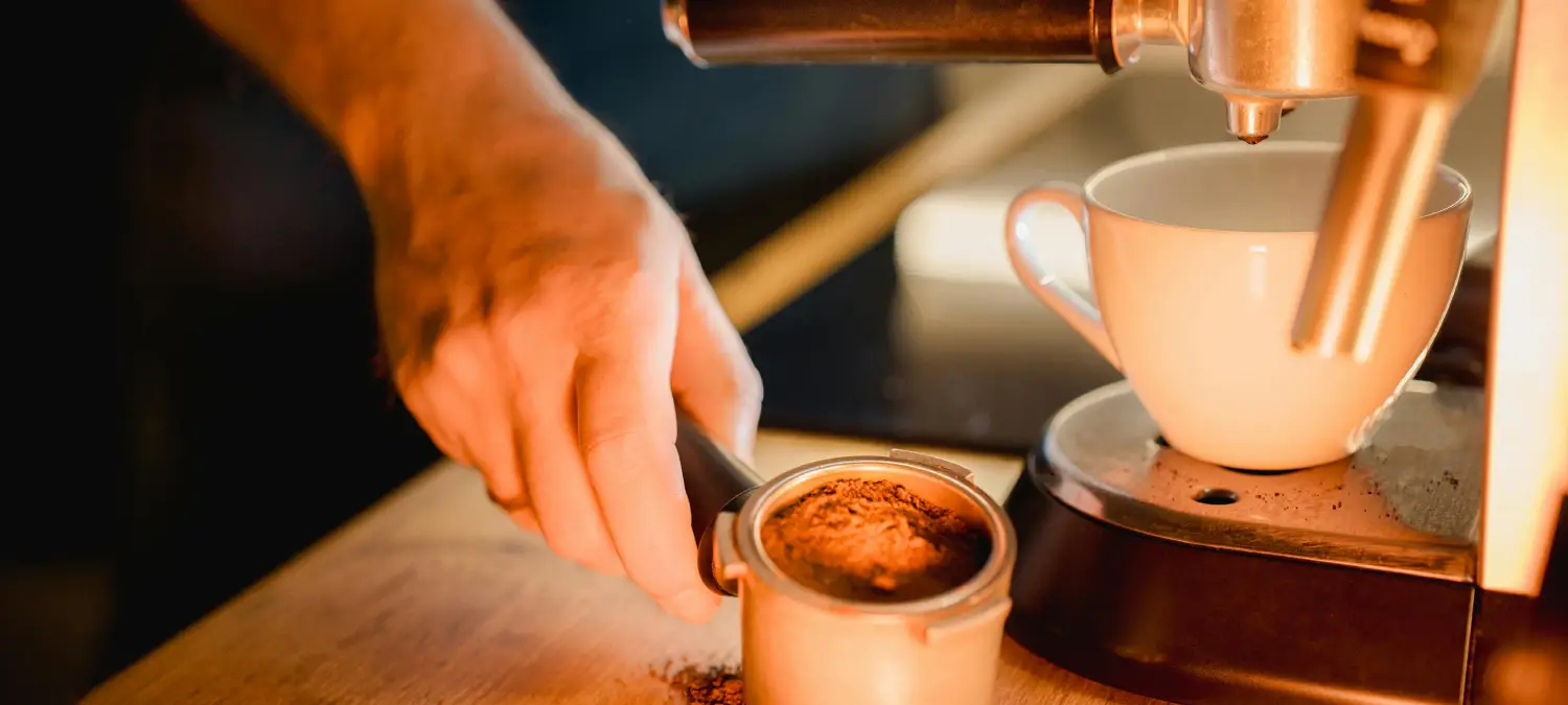 Home Barista Guide: Brew Better Coffee Like a Pro 2 Home barista using an espresso machine to brew coffee at home