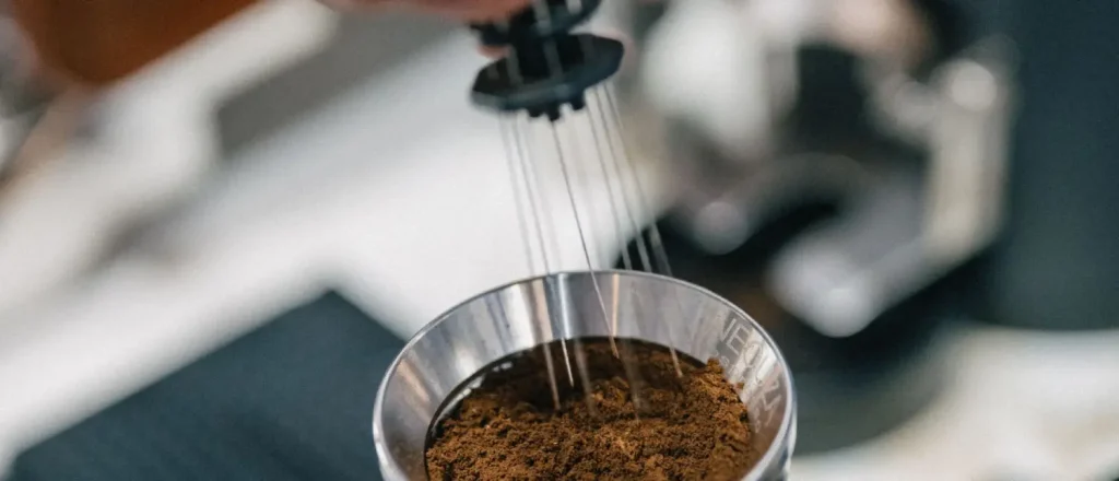 Espresso Distribution Tools: Are They Worth Buying? 53 Espresso distribution tools are used to evenly level coffee grounds in a portafilter before tamping like this person is doing.
