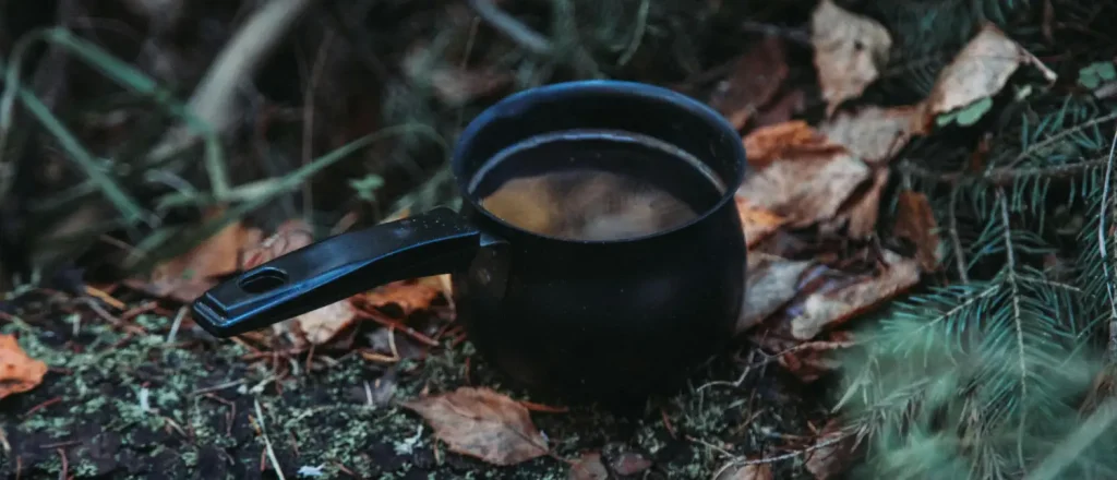 Ryze Chicory Coffee Benefits: Is It Worth Trying? 18 Cup of Ryze chicory coffee with chicory root and functional mushroom ingredients on a wooden table indicating Ryze Chicory Coffee benefits