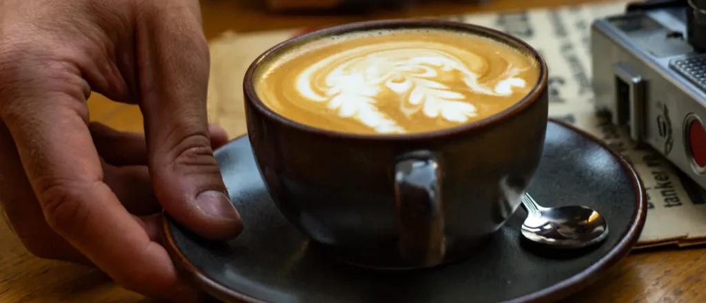 Triple Shot Flat White: Caffeine & Taste Guide 9 Triple shot flat white served on a wooden table with smooth microfoam and rich espresso flavor
