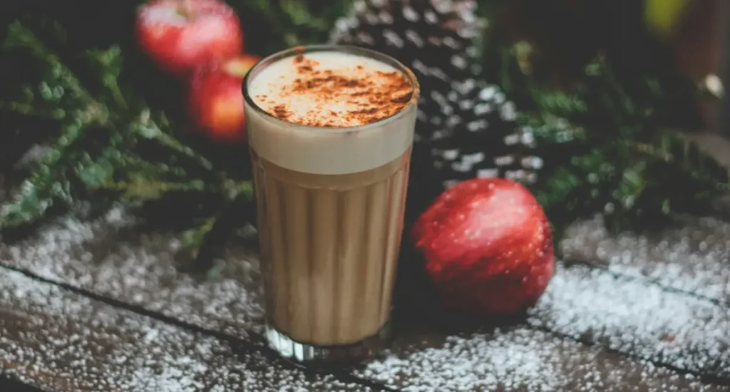 Double Shot Latte: What It Is and Why Coffee Lovers Prefer It ☕✨ 4 A double shot latte surrounded by Christmas decorations on a wooden table